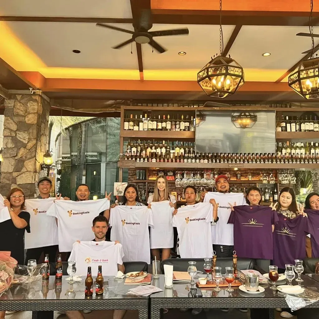 8 A group of people gathered in a restaurant, proudly holding up white and purple t-shirts with